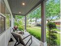 Inviting covered front porch with a relaxing seating area overlooking the front lawn at 1136 W Harvard St, Orlando, FL 32804