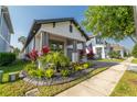 Inviting single-Gathering home with attractive landscaping and a cozy front porch at 15313 Lebeau Loop, Winter Garden, FL 34787