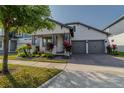 Charming home with a well-manicured lawn, tasteful landscaping, and a welcoming front porch at 15313 Lebeau Loop, Winter Garden, FL 34787