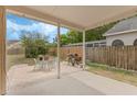 Covered patio with a grill and outdoor seating overlooking a fenced yard at 2051 Pernod Ct, Apopka, FL 32703