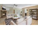 Inviting living room with a cozy fireplace, neutral-toned furniture, modern decor, and bright natural light at 2051 Pernod Ct, Apopka, FL 32703