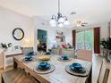 Stylishly decorated dining room featuring a rustic wood table and seating for six guests at 2781 Almaton Loop # 203, Kissimmee, FL 34747