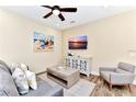 Cozy living room with comfortable seating, stylish décor, and a mounted flatscreen TV for entertainment at 3205 Caribbean Soul Dr, Kissimmee, FL 34747