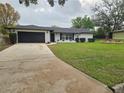 Charming single-story home with well-maintained lawn and extended driveway at 383 Floral Dr, Winter Garden, FL 34787