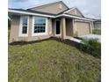 Well-maintained single-Gathering home with a lush green lawn and attached two-car garage at 4236 Sagefield Dr., St Cloud, FL 34773