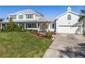 Inviting two-story house with a well-manicured lawn and a spacious two-car garage, exuding curb appeal at 4240 Lake Harney Cir, Geneva, FL 32732