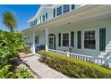 Charming front porch with ample seating, framed by lush greenery and offering a welcoming entrance at 4240 Lake Harney Cir, Geneva, FL 32732