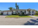 Charming single-story home featuring a well-manicured lawn, brick driveway and an attached two-car garage at 4321 Summer Ln, Orlando, FL 32804