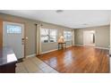 Bright living room featuring hardwood floors, neutral walls, and large windows that bring in ample natural light at 4321 Summer Ln, Orlando, FL 32804