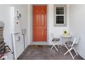 Close-up of front door and brick patio area with table and two chairs at 4839 Jackstaff Way, Oviedo, FL 32765