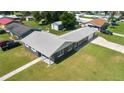 Aerial view of a well-kept home highlighting the newly installed gray roof, landscaping, and neighborhood at 5134 Harvard W St, Lakeland, FL 33810