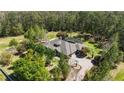 Stunning home with a screened-in pool, lush landscaping, and a circular driveway at 5200 Carson St, St Cloud, FL 34771