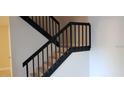 View of staircase with modern black railing and tile risers at 5334 Bamboo Ct # 463, Orlando, FL 32811