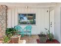 Inviting front porch with seating area and decorative planters at 5441 Justine Way, Winter Park, FL 32792