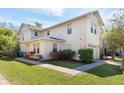 Stunning two-story townhouse with a well-maintained lawn and a paved walkway at 5565 Gelato Dr, Orlando, FL 32829