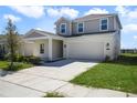 Neutral stucco, stone accents, a two-car garage and an extended driveway at 640 Trotters Dr, Eagle Lake, FL 33839