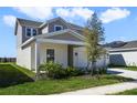 A view of the side of the house showcasing landscaping, and a driveway at 640 Trotters Dr, Eagle Lake, FL 33839