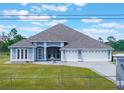 Beautiful single-story home featuring a three-car garage, water fountain, and a spacious front yard at 6607 Whispering Pines Rd, Orlando, FL 32824