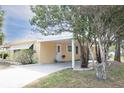 Inviting home featuring mature trees, a carport, and well-manicured landscaping at 726 Viking Ave, Tavares, FL 32778
