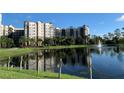 Scenic view of a multi-story building from across the pond reflecting the building and blue sky at 14501 Grove Resort Ave # 3222, Winter Garden, FL 34787