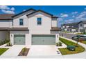 Charming townhome with a two-car garage and beautifully landscaped front yard at 818 Poppy Ln, Dundee, FL 33838