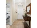 Inviting entryway featuring tiled floors, decorative mirror and console table, and an interior view of the bedroom at 8944 Sugar Palm Rd, Kissimmee, FL 34747