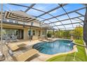 Inviting screened-in pool area with lounge chairs and a mini golf course for outdoor enjoyment at 9254 Reymont St, Orlando, FL 32827