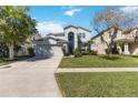 Charming two-story home featuring a well-manicured lawn and an attached two-car garage at 9826 Heron Pointe Dr, Orlando, FL 32832