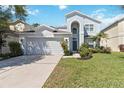Charming two-story home featuring a well-manicured lawn and an attached two-car garage at 9826 Heron Pointe Dr, Orlando, FL 32832