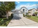 Charming two-story home featuring a well-manicured lawn and an attached two-car garage at 9826 Heron Pointe Dr, Orlando, FL 32832