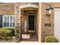 Up close exterior showcasing a charming brick entryway with a 'Welcome' sign and manicured landscaping at 1638 Swallowtail Ln, Sanford, FL 32771