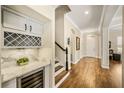 Hallway with stairs and a built-in bar area with wine storage at 1638 Swallowtail Ln, Sanford, FL 32771