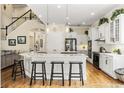 Bright, eat-in kitchen features an island with bar seating, stainless appliances, and white cabinetry at 1638 Swallowtail Ln, Sanford, FL 32771