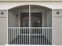Screened balcony with white rails offering partial view of building with tile roof at 2615 Maitland Crossing Way # 9 307, Orlando, FL 32810