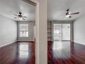 Open concept living room featuring hardwood floors, and sliding glass doors to balcony at 2615 Maitland Crossing Way # 9 307, Orlando, FL 32810