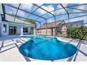 Inviting screened-in pool with clear blue water surrounded by a patio at 430 Langham Dr, Davenport, FL 33897