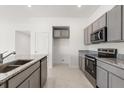 Modern kitchen featuring granite countertops, stainless steel appliances, and ample cabinet space at 640 Royal Palm Dr, Dundee, FL 33838