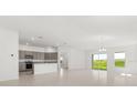 Bright living space with tile flooring, recessed lighting, and seamless access to kitchen and outdoor views at 640 Royal Palm Dr, Dundee, FL 33838