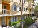 Exterior angle view of the townhome with white picket fence, balcony, and lush landscaping at 728 Greybull Run, Lake Mary, FL 32746