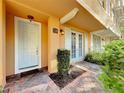 Close up of charming townhome front entrance featuring a light blue door and brick-paver walkway at 728 Greybull Run, Lake Mary, FL 32746