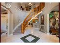 Entryway with wooden staircase and tile flooring at 11450 Nellie Oaks Bnd, Clermont, FL 34711