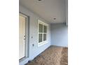 Exterior features light blue stucco with white trim, a window, and front door at 13075 Se 35Th Ct, Belleview, FL 34420
