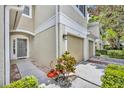 Charming townhome showcasing well-maintained landscaping, an attached garage, and a covered front entrance at 1541 Florentino Ln, Winter Park, FL 32792