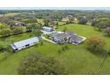 Aerial view of estate home with multiple structures and large grassy property at 17726 Dangler Rd, Winter Garden, FL 34787