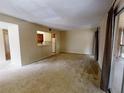 Inviting living room featuring a view to kitchen and balcony access with neutral decor at 190 Hickory Woods Ct # 1B, Deltona, FL 32725