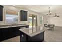 Modern kitchen featuring granite countertops, stainless steel appliances, and a central island at 2200 Rapollo Dr, Kissimmee, FL 34741
