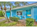 Inviting front entrance with brick walkway, chairs, and lush landscaping adding to its curb appeal at 2565 Brookshire Ave, Winter Park, FL 32792