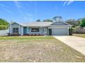Charming single-story home with a well-manicured lawn and a one-car garage at 2617 Greywall Ave, Ocoee, FL 34761