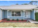 A cozy front porch with decorative trim, well kept flower bed and beautiful landscaping at 2617 Greywall Ave, Ocoee, FL 34761