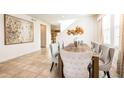 Bright dining room featuring a wooden table with seating for six, neutral walls, and tile flooring at 291 Pendant Ct, Kissimmee, FL 34747